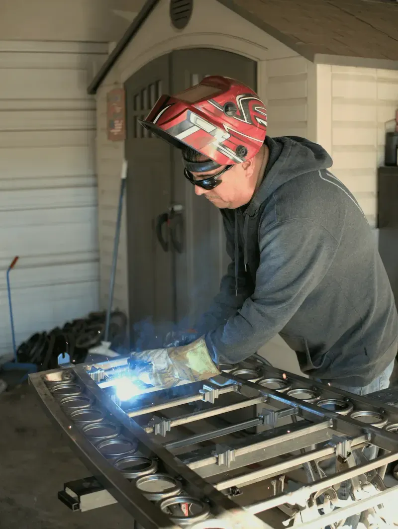 DC Iron welder welding a steel gate frame in the shop