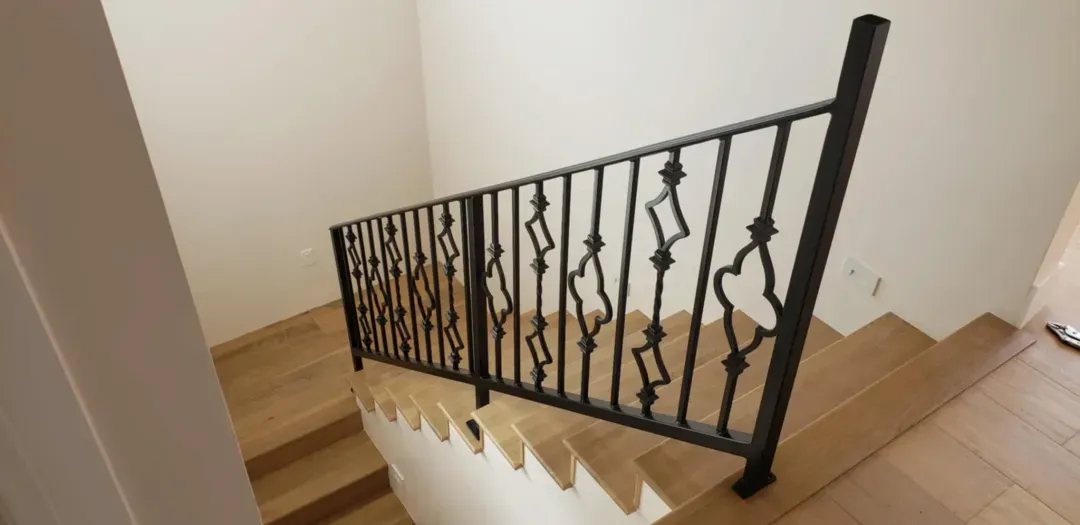 Wrought iron stair railing on a wood staircase