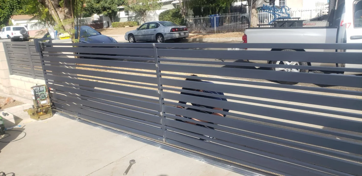 A man is standing behind a fence.